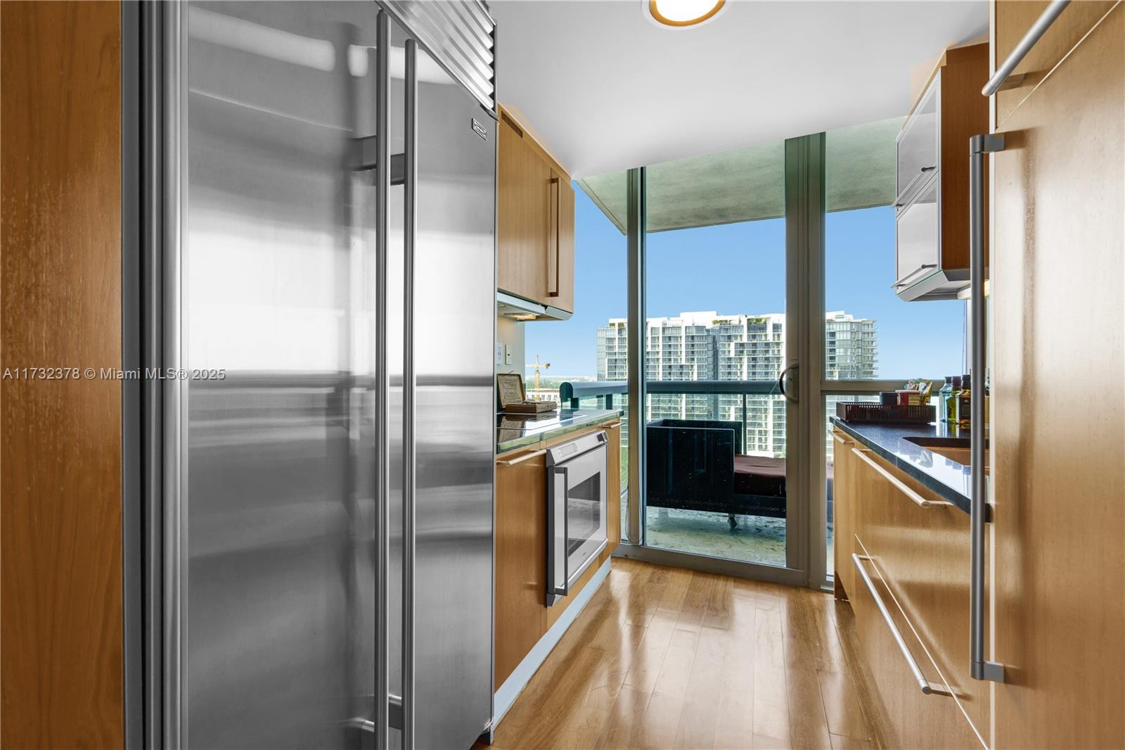 101 20th Street, Unit 1805 Miami Beach, FL 33139 - Photo 15 of 50 a kitchen with a refrigerator and white cabinets