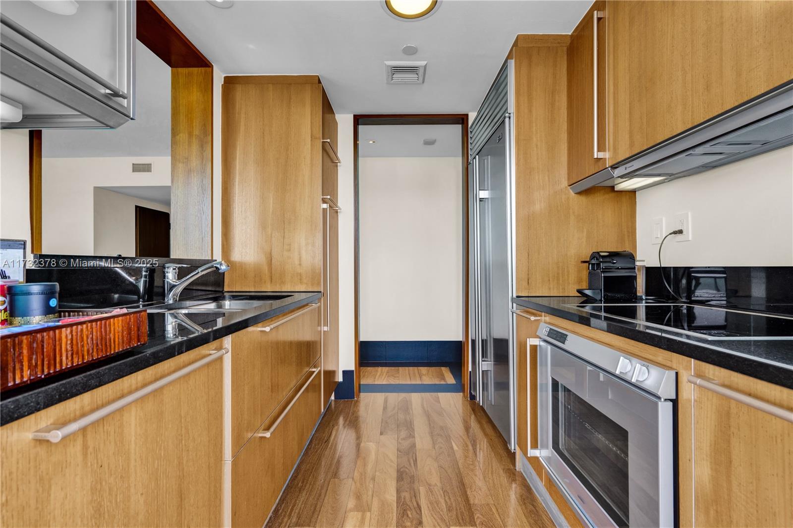101 20th Street, Unit 1805 Miami Beach, FL 33139 - Photo 17 of 50 a kitchen with stainless steel appliances a sink and cabinets