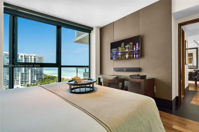 a bedroom with a bed and a large window