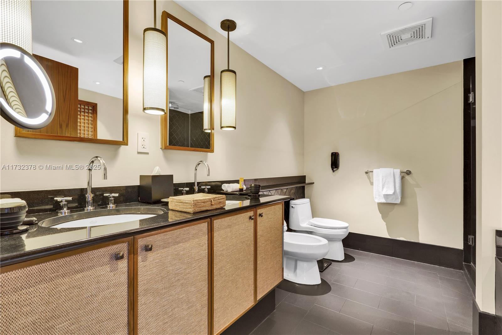 101 20th Street, Unit 1805 Miami Beach, FL 33139 - Photo 26 of 50 a bathroom with a sink a toilet and a mirror