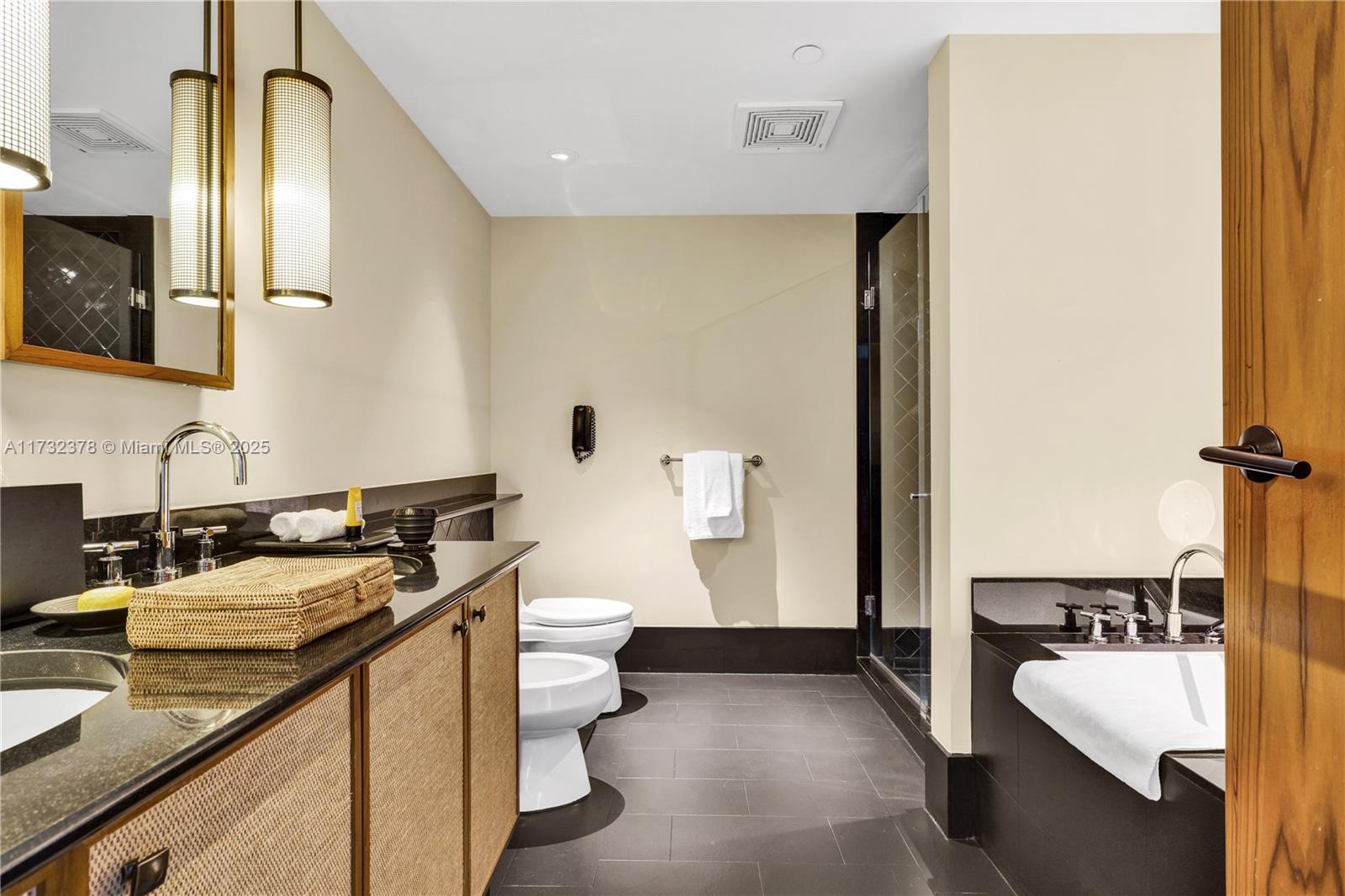 101 20th Street, Unit 1805 Miami Beach, FL 33139 - Photo 27 of 50 a bathroom with a sink a toilet and mirror