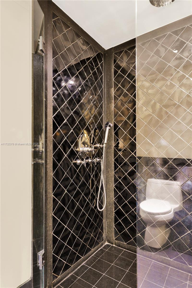 101 20th Street, Unit 1805 Miami Beach, FL 33139 - Photo 30 of 50 a bathroom with a toilet and a shower