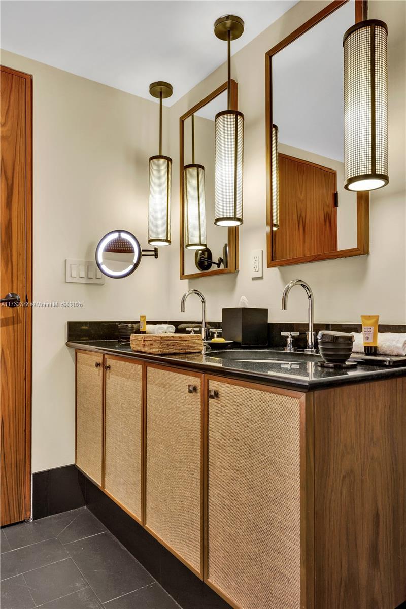 101 20th Street, Unit 1805 Miami Beach, FL 33139 - Photo 31 of 50 a bathroom with a double vanity sink and a mirror