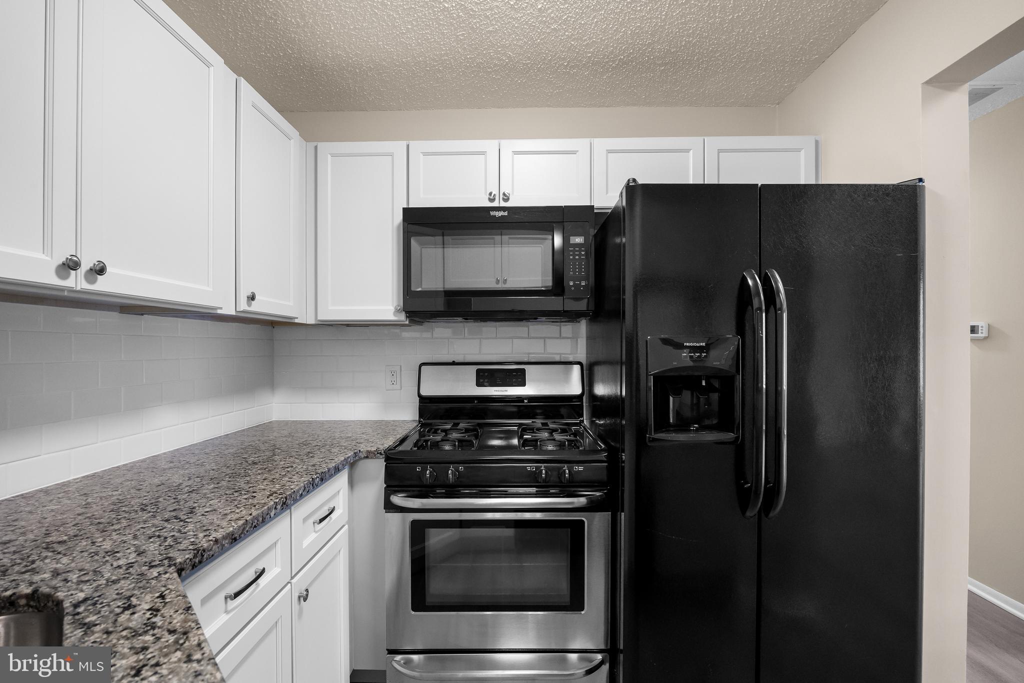4904B Dunbarton Road Mount Laurel, NJ 08054 - Photo 11 of 27 a kitchen with stainless steel appliances granite countertop a refrigerator stove and microwave