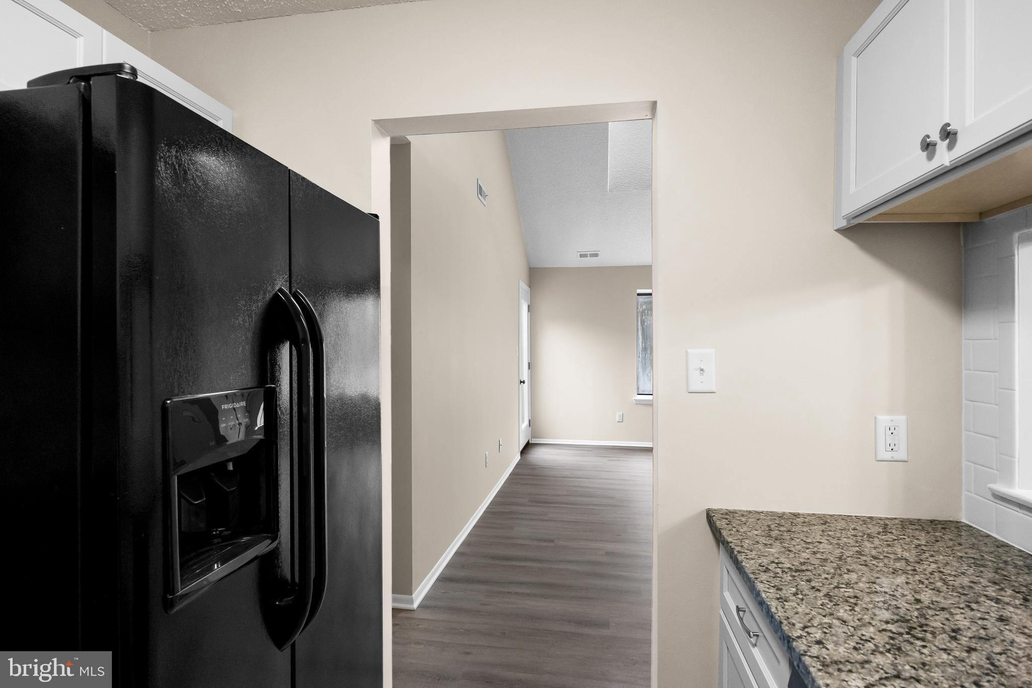 4904B Dunbarton Road Mount Laurel, NJ 08054 - Photo 12 of 27 a view of a kitchen with a refrigerator and wooden floor