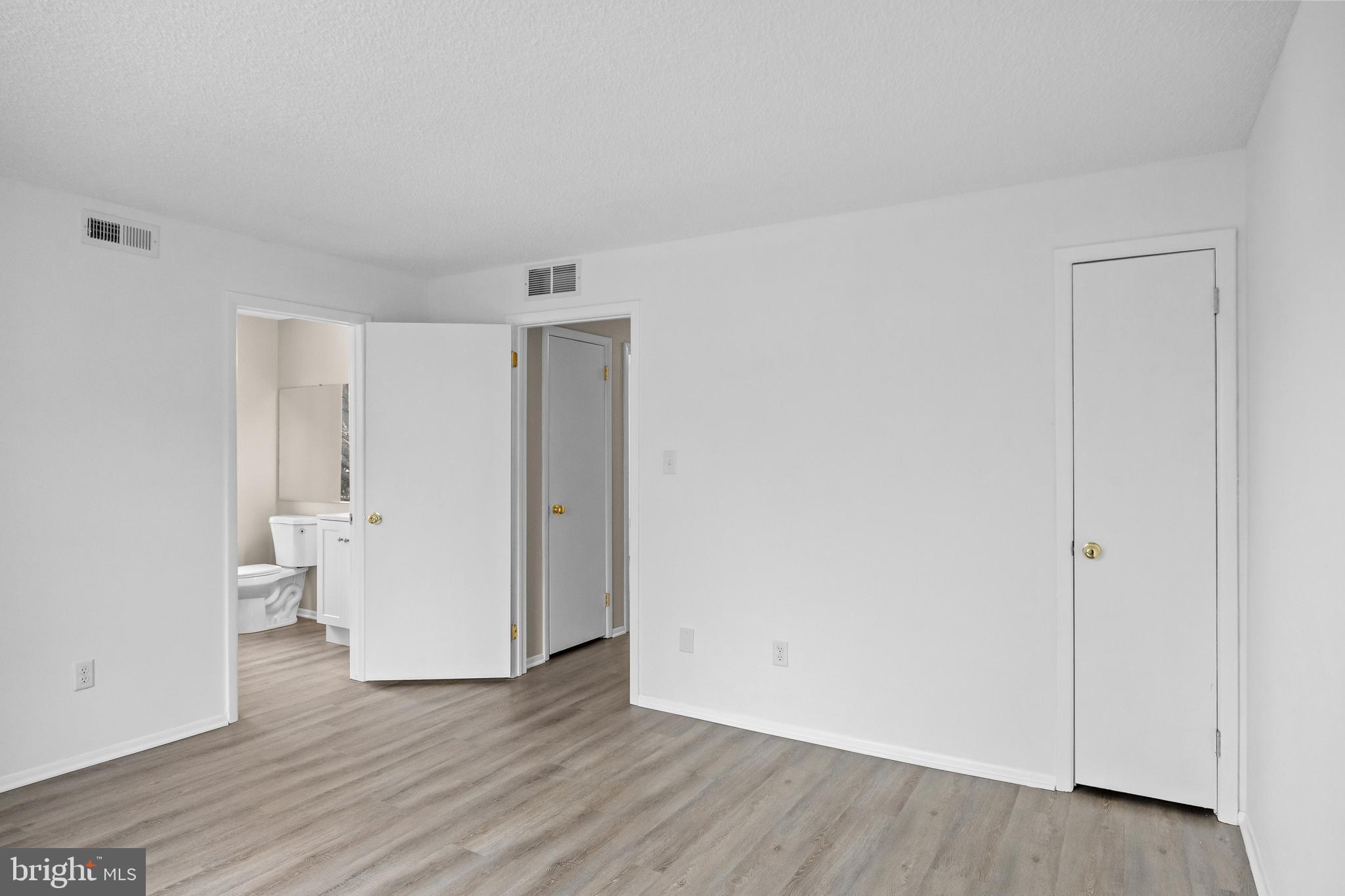 4904B Dunbarton Road Mount Laurel, NJ 08054 - Photo 14 of 27 a view of an empty room with wooden floor and closet