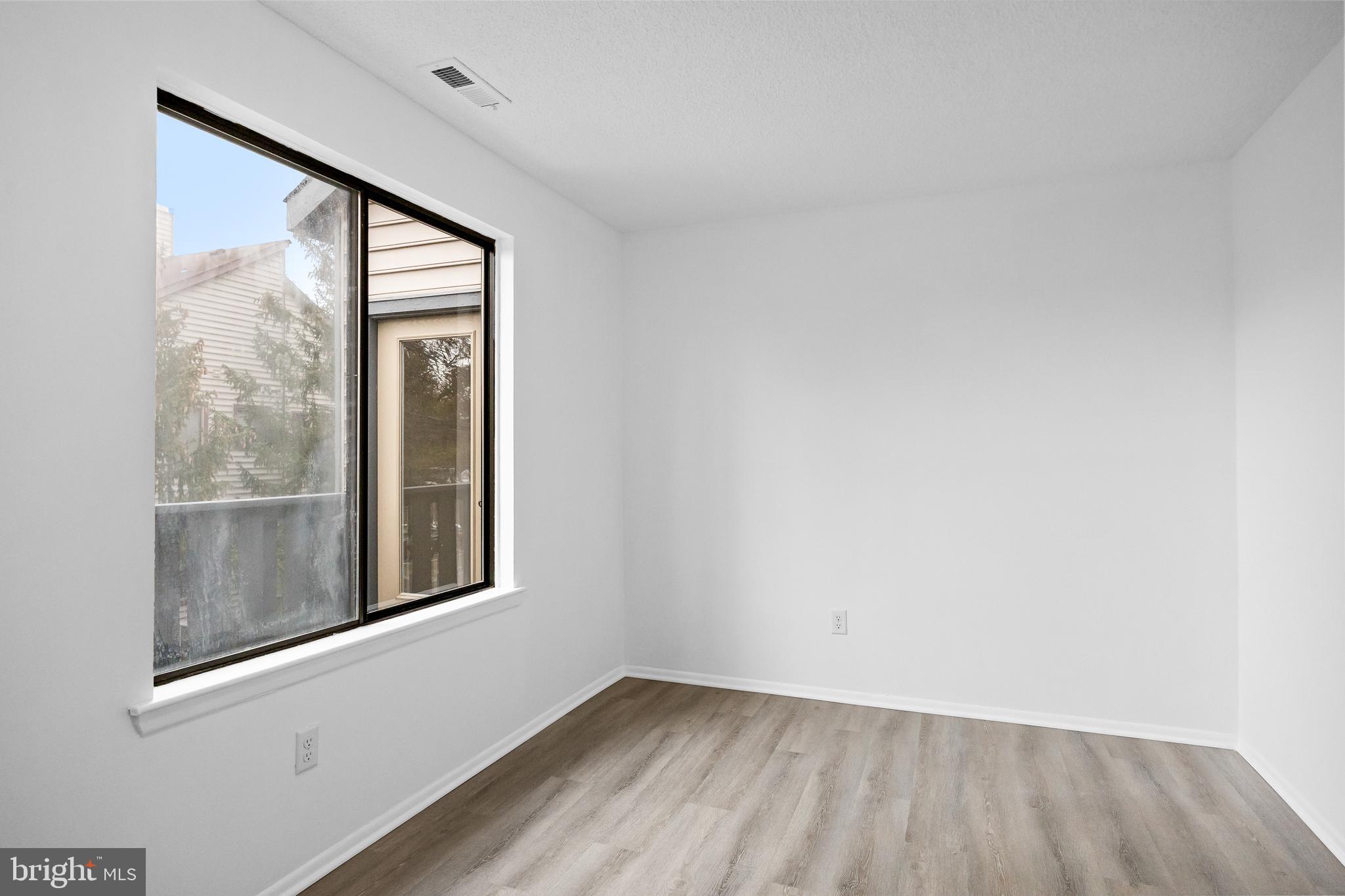 4904B Dunbarton Road Mount Laurel, NJ 08054 - Photo 17 of 27 a view of an empty room with a window and wooden floor