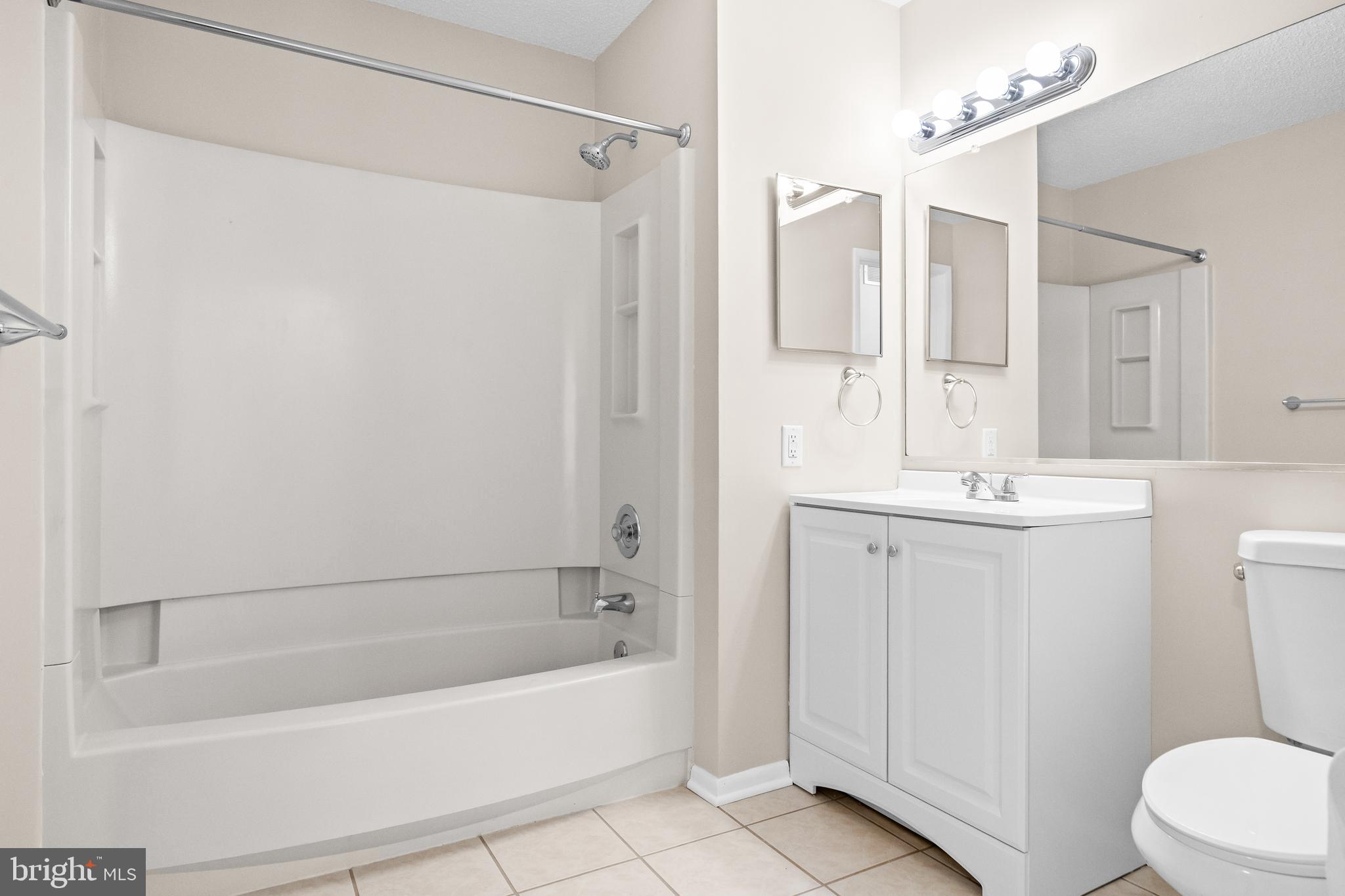 4904B Dunbarton Road Mount Laurel, NJ 08054 - Photo 19 of 27 a bathroom with a sink a toilet a mirror a bathtub and shower