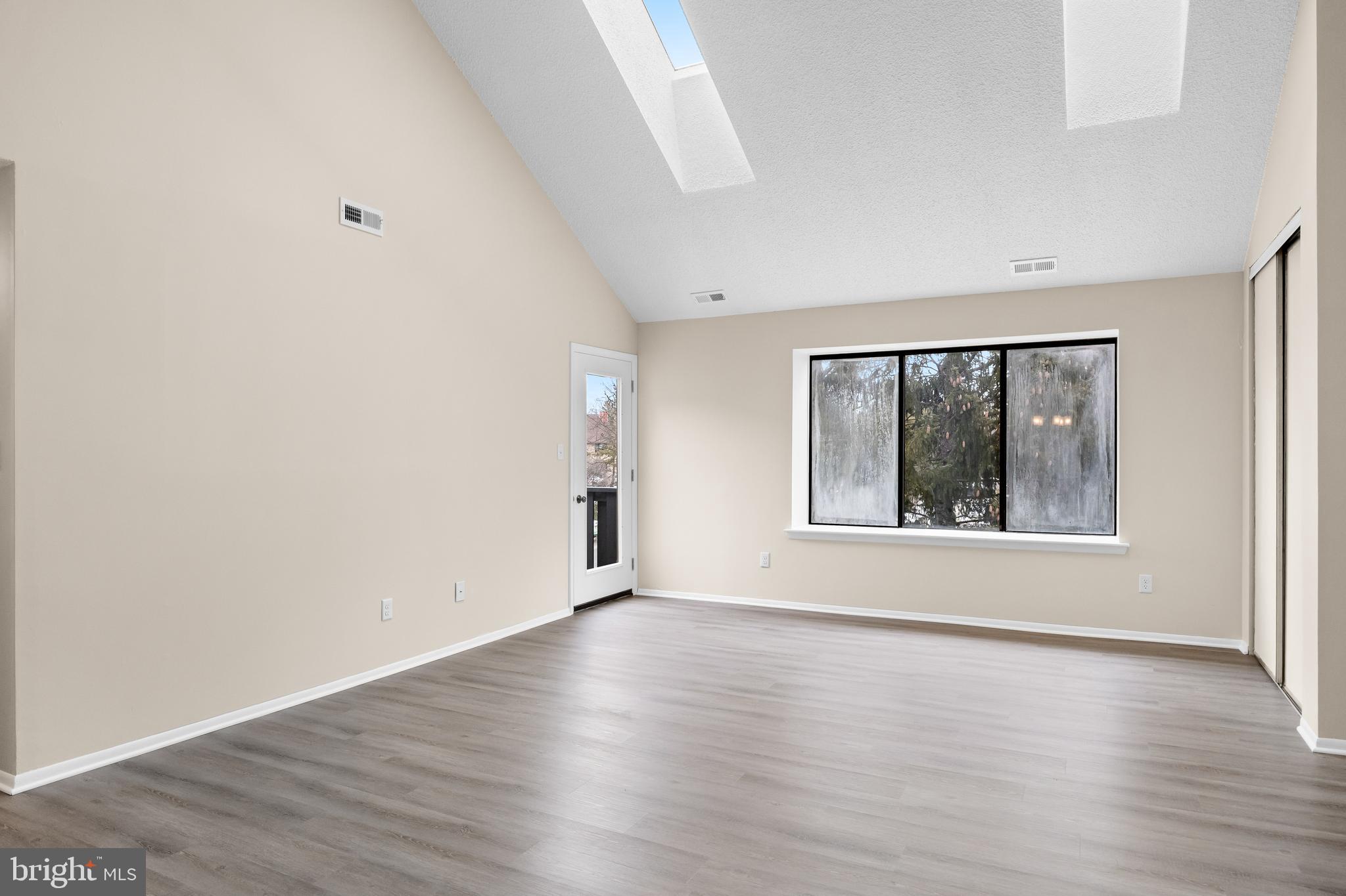 4904B Dunbarton Road Mount Laurel, NJ 08054 - Photo 4 of 27 an empty room with wooden floor and windows