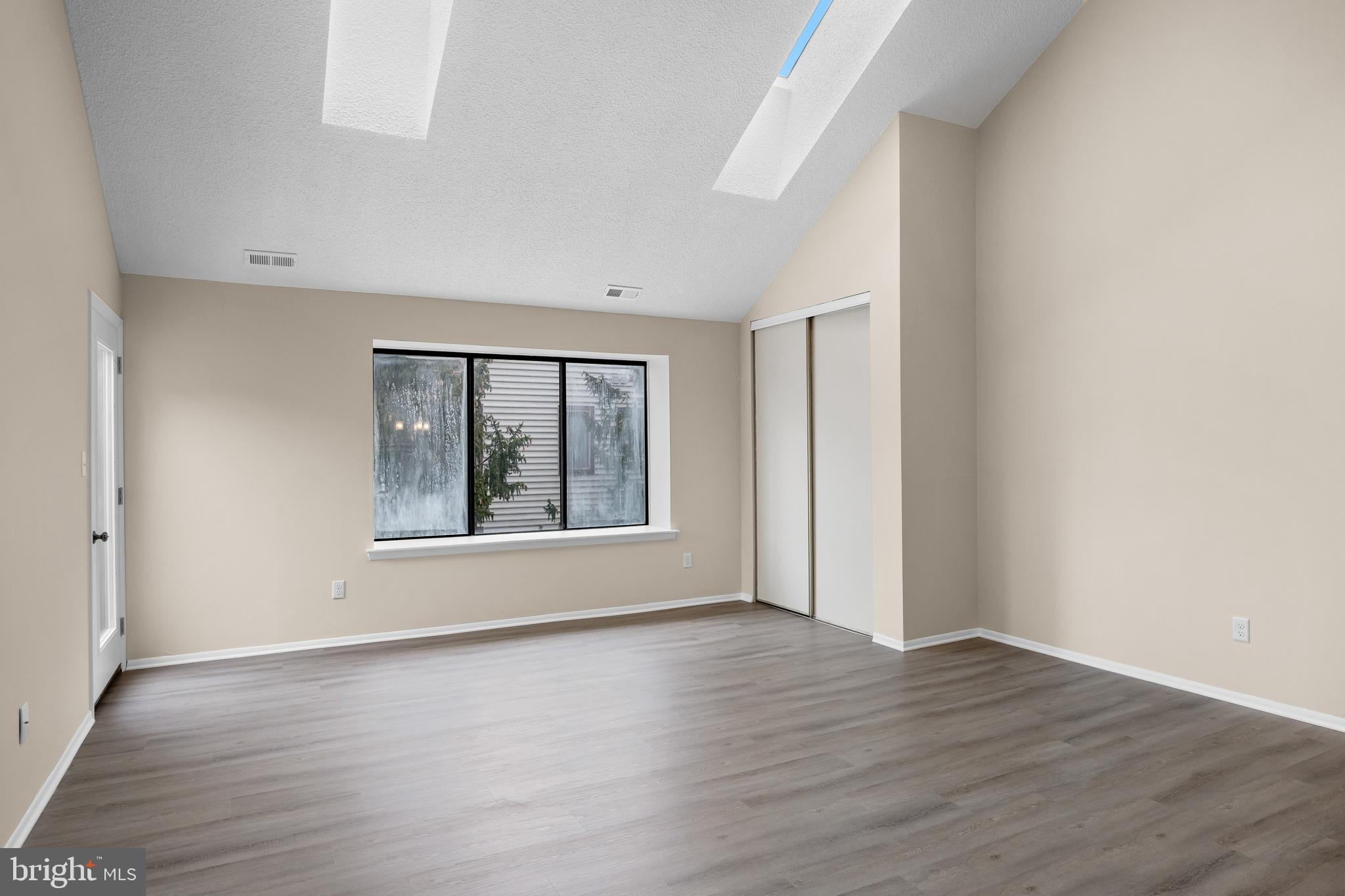 4904B Dunbarton Road Mount Laurel, NJ 08054 - Photo 5 of 27 an empty room with wooden floor and windows