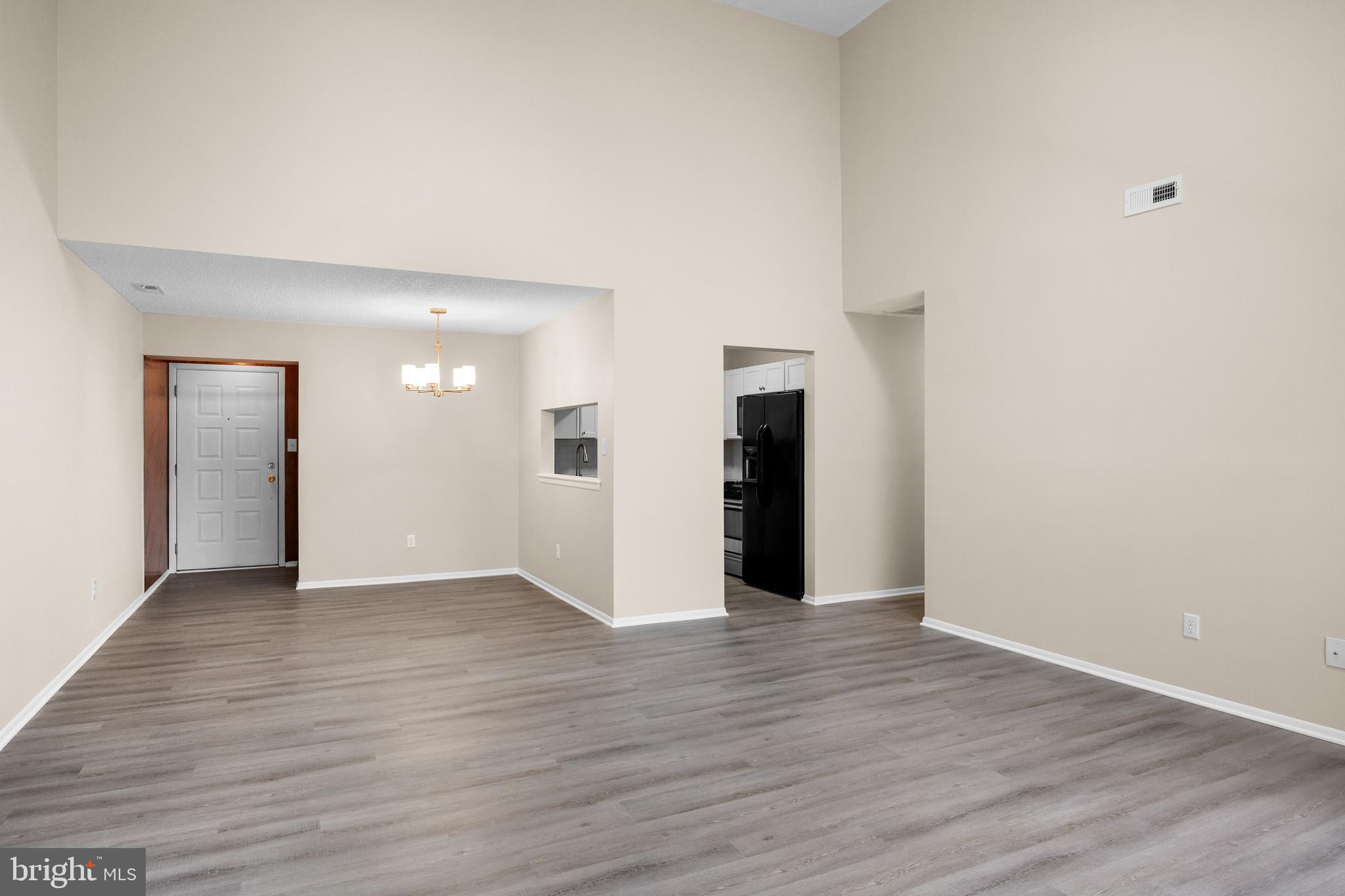 4904B Dunbarton Road Mount Laurel, NJ 08054 - Photo 7 of 27 a view of an empty room with wooden floor and a window