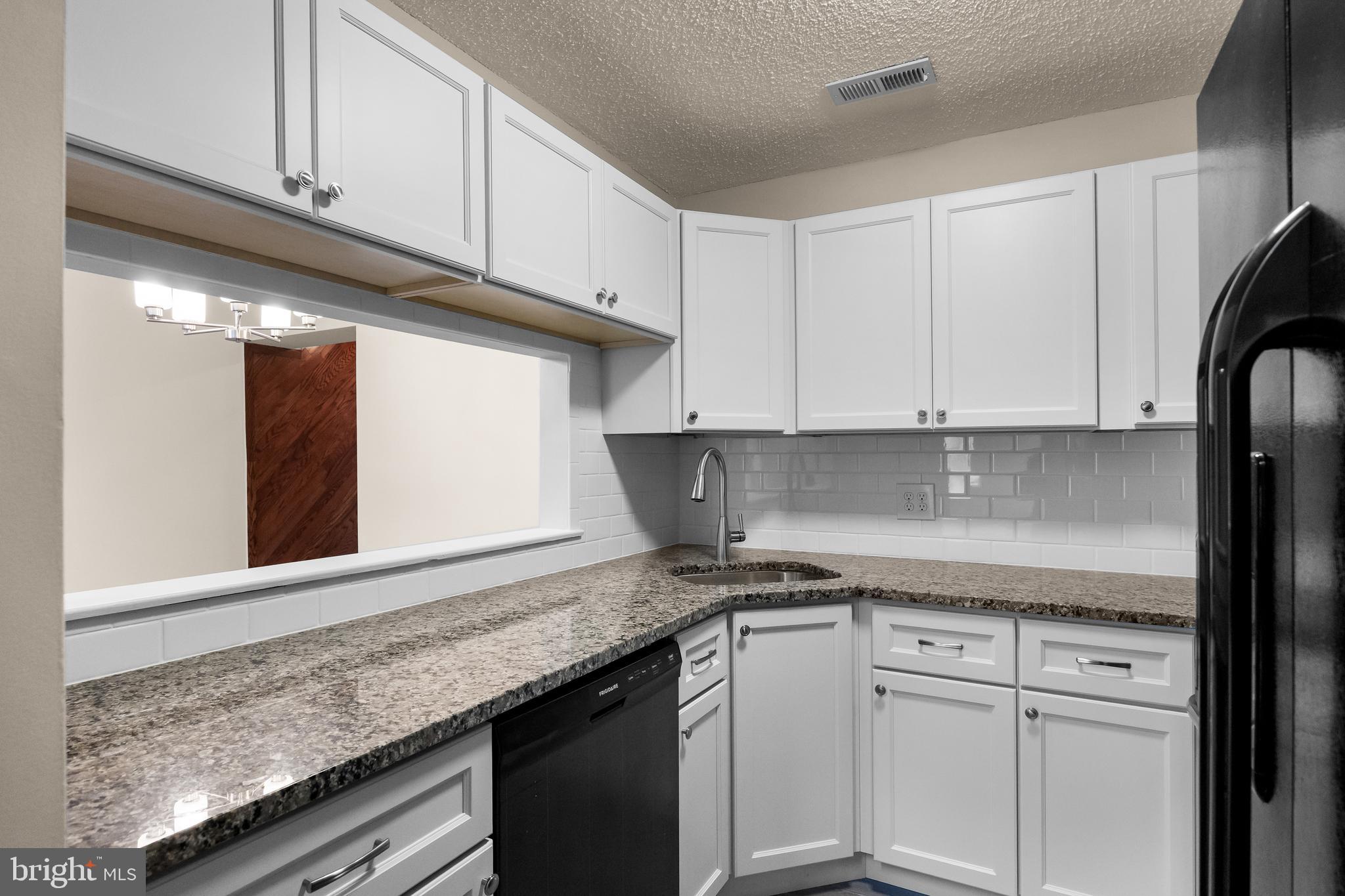 4904B Dunbarton Road Mount Laurel, NJ 08054 - Photo 9 of 27 a kitchen with granite countertop a sink and cabinets