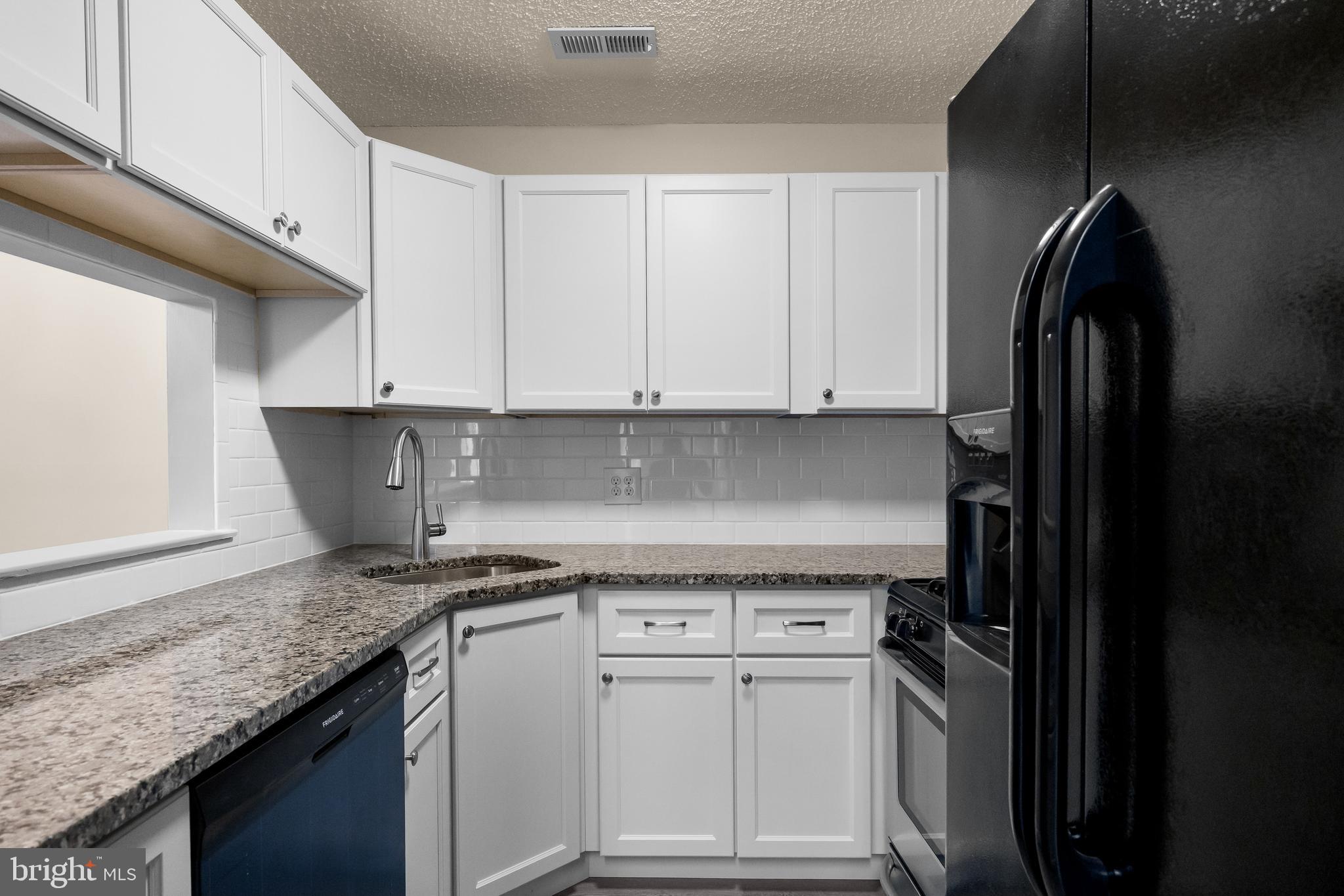 4904B Dunbarton Road Mount Laurel, NJ 08054 - Photo 10 of 27 a kitchen with stainless steel appliances granite countertop a refrigerator a sink a stove and white cabinets