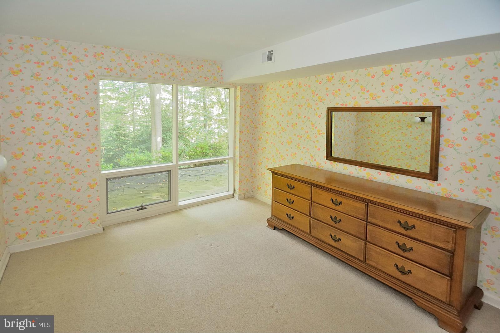1925 Marthas Road Alexandria, VA 22307 - Photo 22 of 29 a spacious bedroom with a bed and a mirror on the dresser