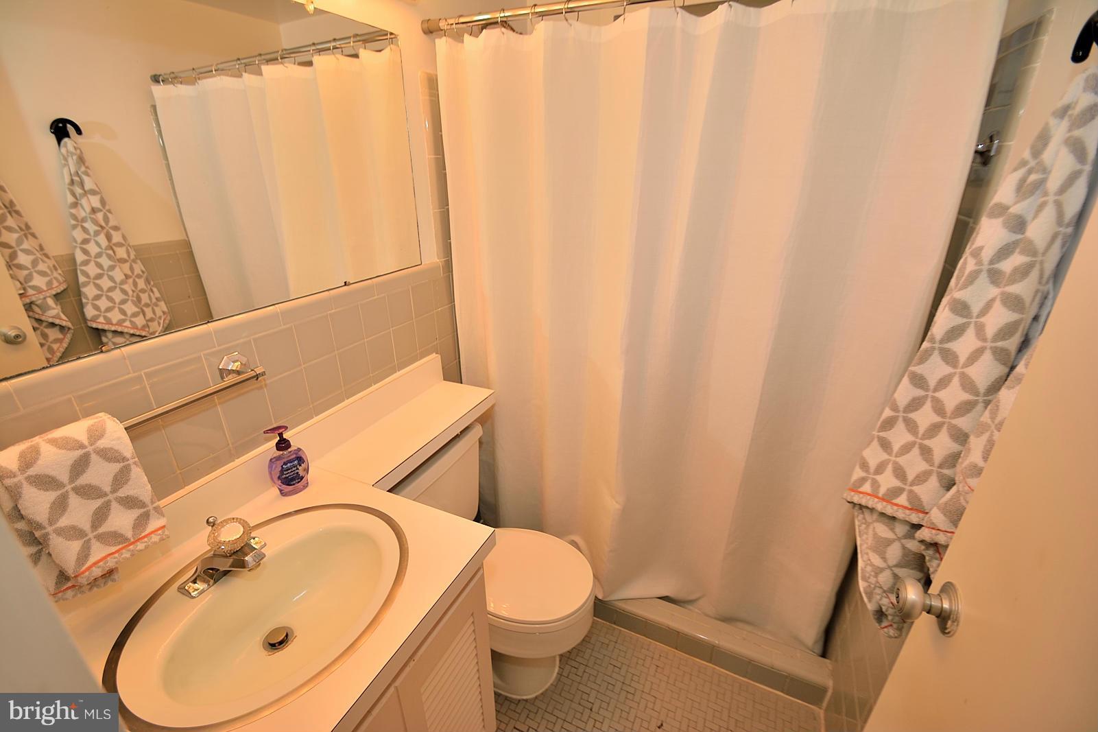 1925 Marthas Road Alexandria, VA 22307 - Photo 23 of 29 a bathroom with a sink a toilet and shower curtain