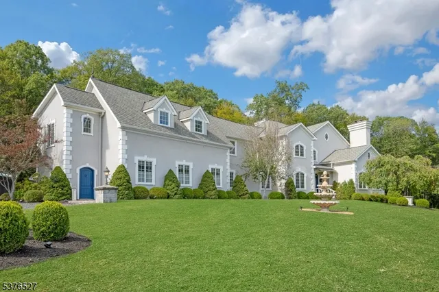 a front view of a house with a garden and plants