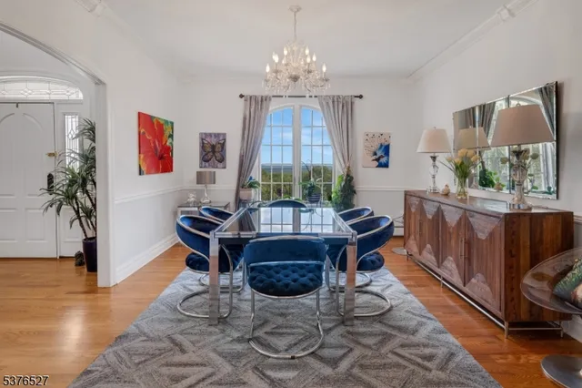 a living room with furniture a window and a chandelier