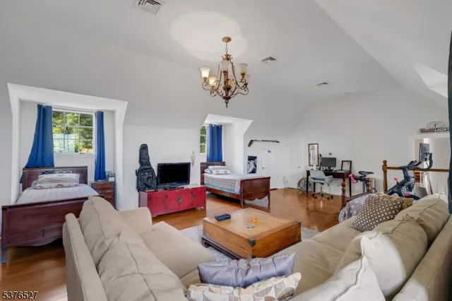 a living room with furniture or chandelier and a flat screen tv
