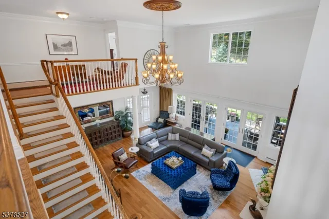 a living room with furniture and a chandelier