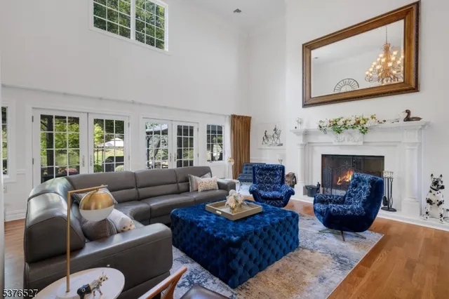 a living room with furniture two window and a fireplace