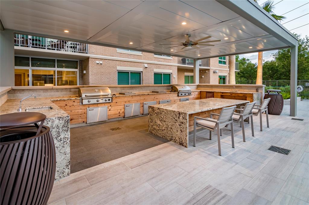 4719 Cole Avenue, Unit 266 Dallas, TX 75205 - Photo 25 of 35 a dining hall with stainless steel appliances granite countertop a barbecue grill and couches chair with granite countertops