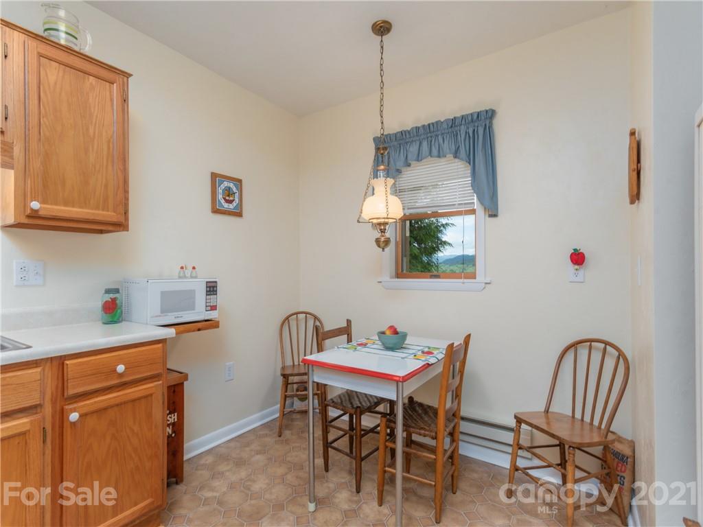 311 Walnut Ford Road Waynesville, NC 28785 - Photo 22 of 33 a view of a dining room with furniture and window