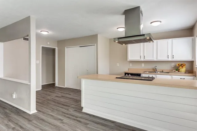 a kitchen with stainless steel appliances granite countertop a stove and a refrigerator