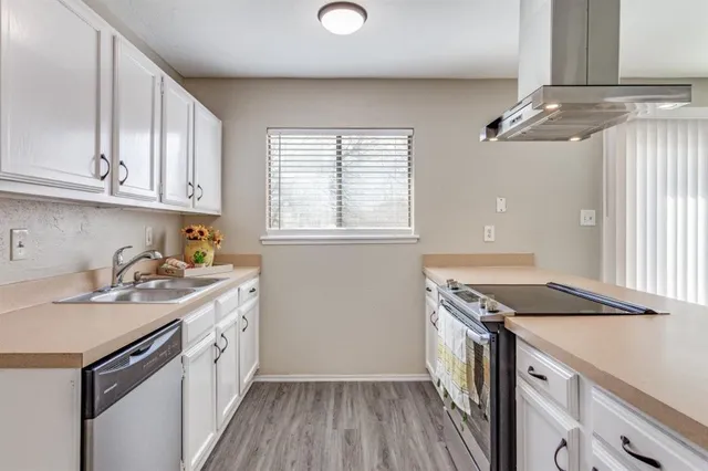 a kitchen that has a sink and a stove