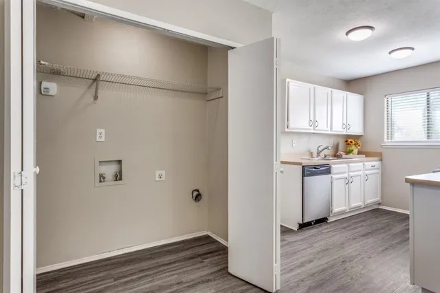 a view of a kitchen with a sink a refrigerator and window