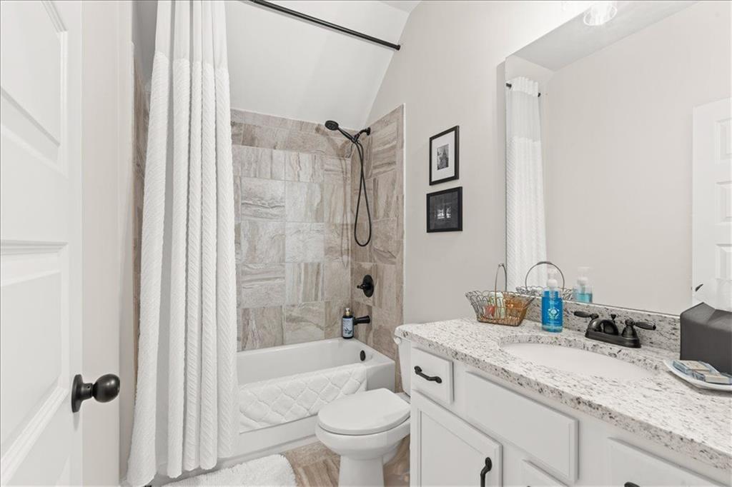 7610 Scenic Overlook Cumming, GA 30041 - Photo 38 of 62 a bathroom with a granite countertop sink a toilet a mirror and shower