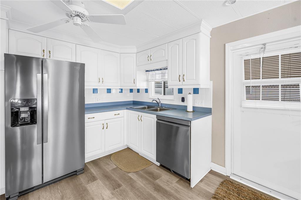 1100 South Belcher Road, Unit 502 Largo, FL 33771 - Photo 11 of 51 a kitchen with white cabinets and stainless steel appliances