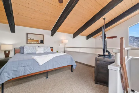 a bedroom with a bed window and wall painting