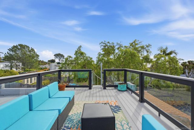 a kitchen with stainless steel appliances kitchen island granite countertop a dining table chairs and a refrigerator