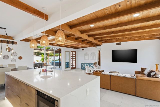 a kitchen with a sink dishwasher and a stove with white countertops