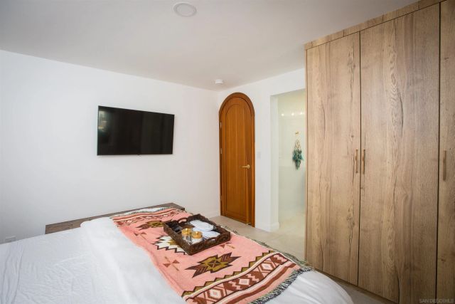 a view of a patio with wooden chairs
