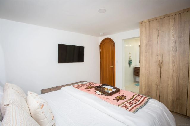 a backyard of a house with table and chairs a barbeque with wooden fence