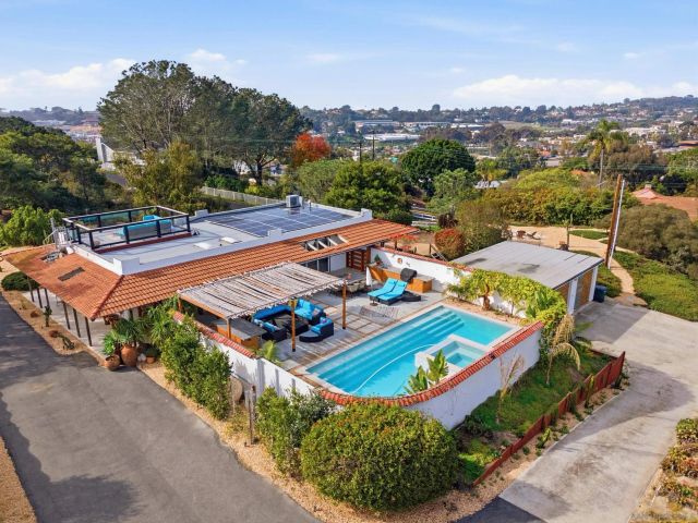 a living room with lots of furniture and a large window