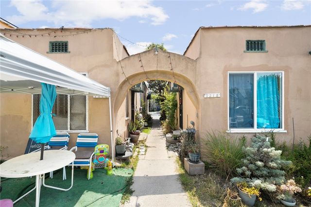 a view of a house with backyard sitting area and garden