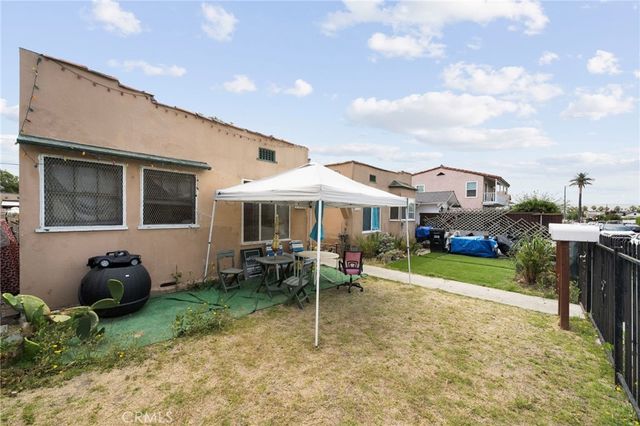 a front view of a house with garden and patio