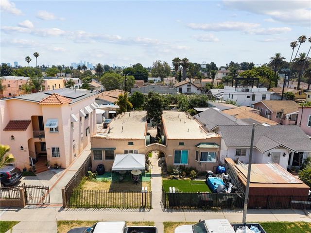 an aerial view of residential house with parking