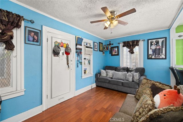 a living room with furniture and ceiling fan