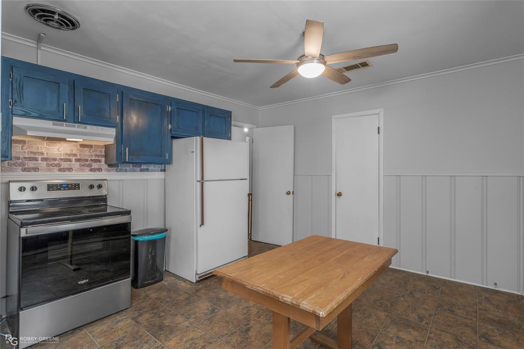 5725 Harper Road Keithville, LA 71047 - Photo 32 of 35 a kitchen with a refrigerator and a stove top oven