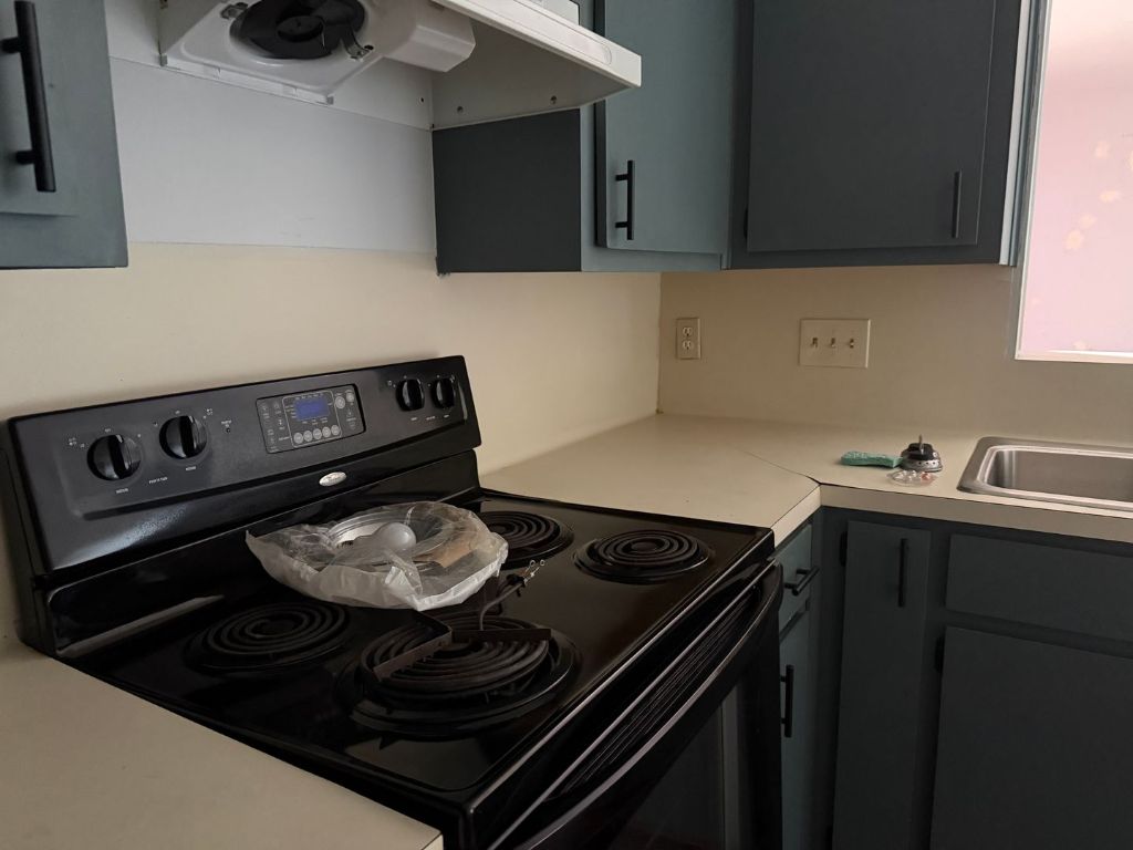 5506 Rose Hill Circle, Unit B Austin, TX 78745 - Photo 3 of 9 a kitchen with a stove and a microwave