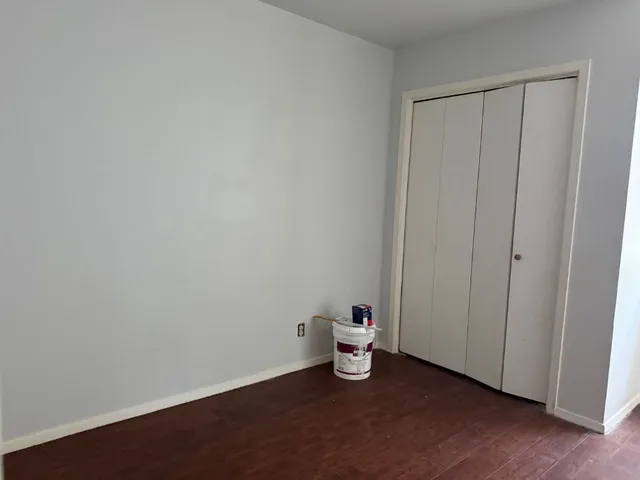 a view of a room with wooden floor