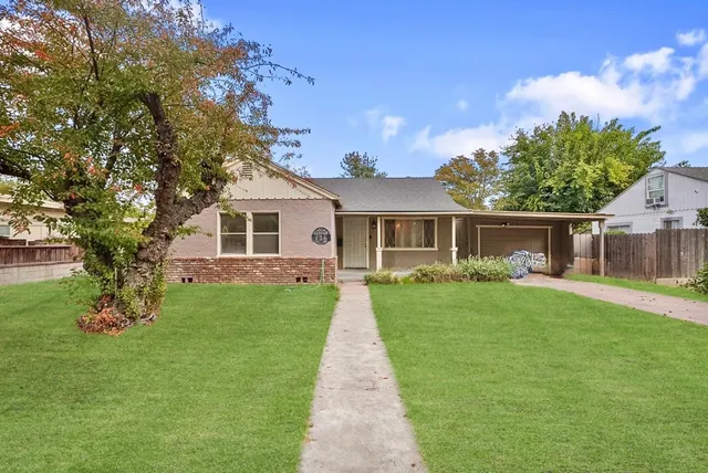 a front view of a house with garden