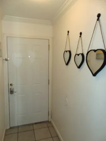 a bedroom with a microwave and cabinets