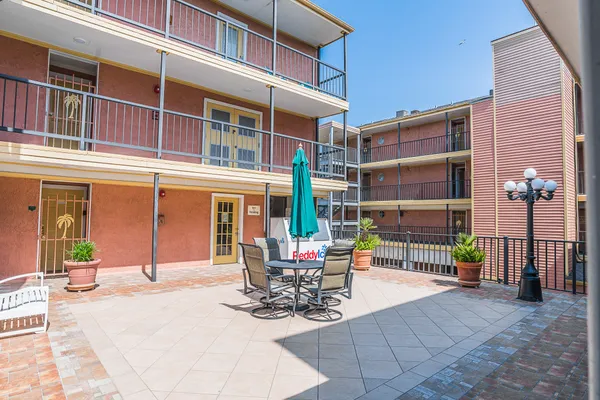 a balcony with table and chairs