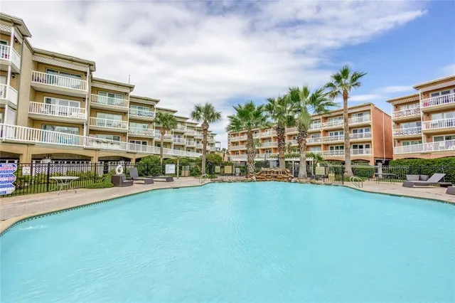 a view of a patio with a table and chairs and potted plants