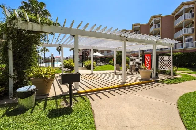 a view of a house with a yard and a tree