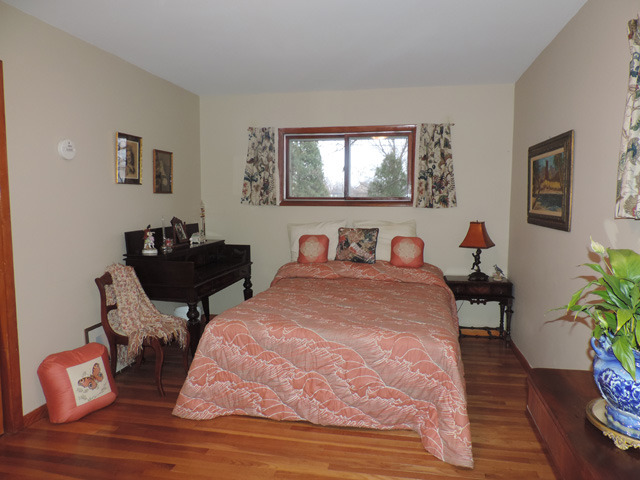 19610 West Manhattan Road Elwood, IL 60421 - Photo 3 of 17 a bed room with a bed and a chair